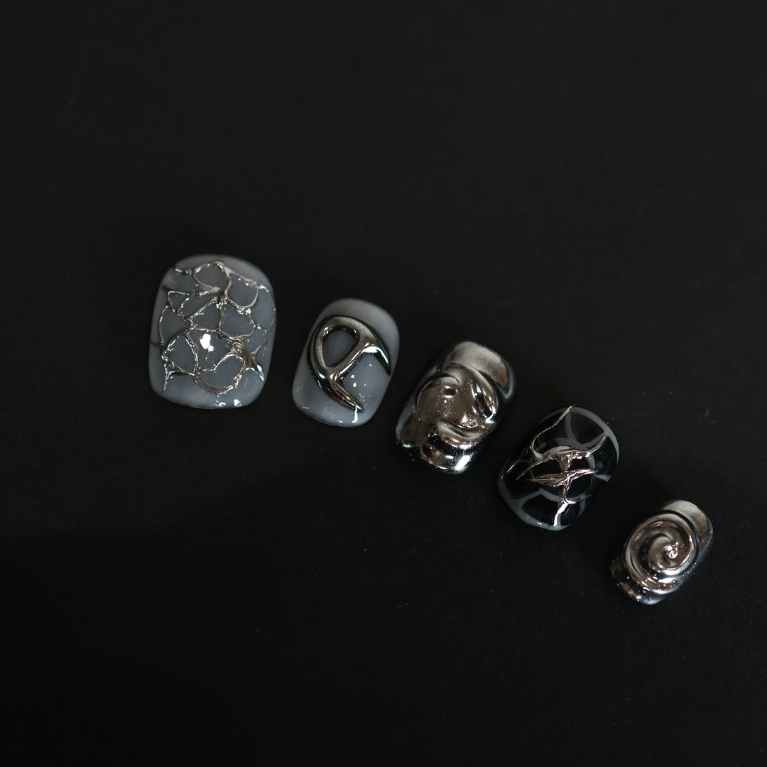 X-Edge press-on nails laid out in close-up, monochrome cybercore and grunge design with liquid metal chrome, crackle textures