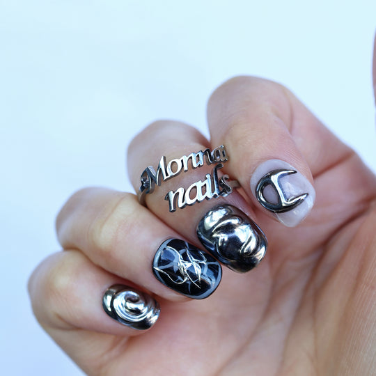 X-Edge cybercore grunge press-on nails with monochrome chrome 3D metal details shown worn on hand