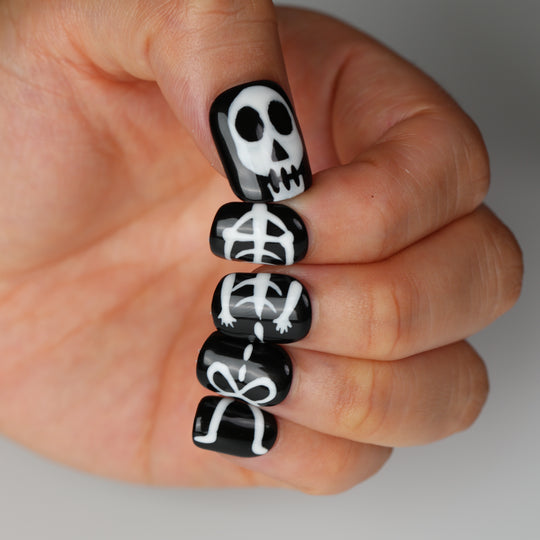 Bone Party press on nails with black-and-white skeleton nail art and spooky Halloween details
