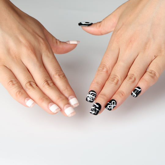 Bone Party press on nails with black skeletal art and white bandage stripes for Halloween