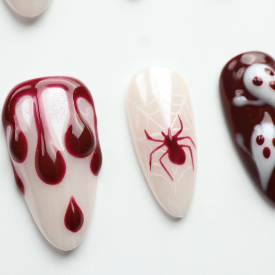 Boo &amp; Blood press on nails with wine-red drips, spiderwebs, and spooky Halloween details on pale backgrounds