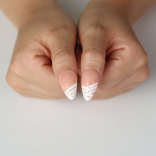 Peekaboo Mummy press-on nails on hands with nude gloss and white bandage stripes