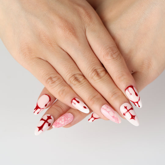 Blood Lace press-on nails on hand, pink base with red cross, dripping and lace designs